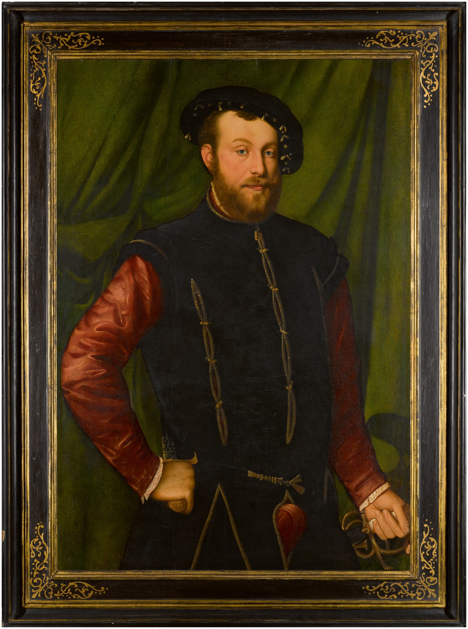 15 Portrait of a gentleman, three-quarter length, wearing a black cap, a black-slashed singlet over a red shirt, holding a sword and a dagger, standing before a green curtain.jpg
